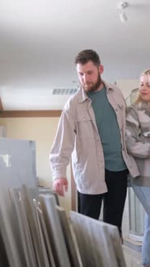 A Young Couple Considers What Color to Choose for Their Home at a Ceramic Tile Shop Vertical Video