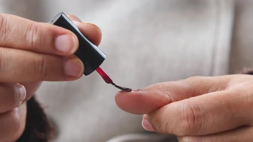 Applying Nail Polish in a Cozy Setting at Home