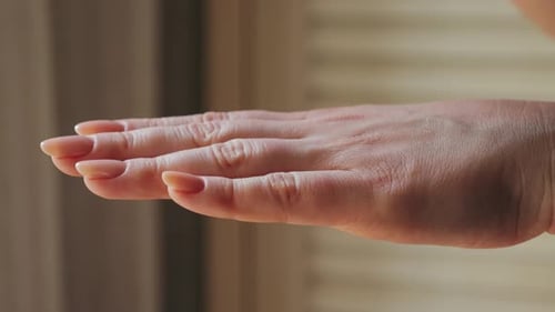 Hand Receives Lotion in a Close Up Shot
