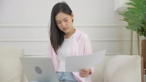 Woman Working on Laptop at Home