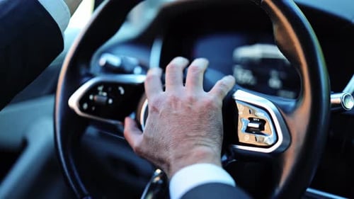 Businessman Honking Car Horn During Impatient Drive in a Modern Vehicle