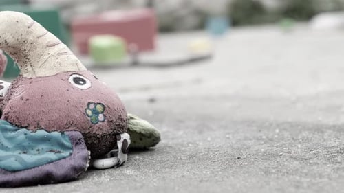 Children's Dirty Wet Toy Toy Lying on the Playground The Concept of Lost Childhood or Poor