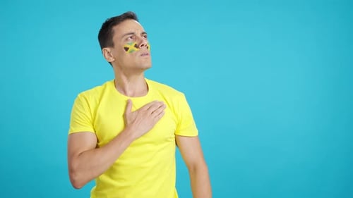 Man Listening to the Jamaica National Anthem with Solemnity