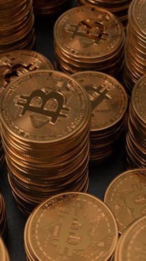 Bitcoins stacked on glossy black background