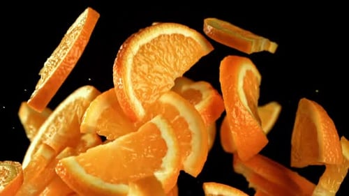 Orange Slices Flying on a Black Background Filmed on a Highspeed Camera at 1000 Fps