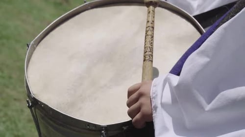 Drum With Drumstick Resting on Surface
