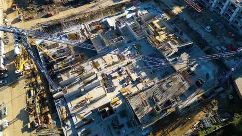 Aerial Flight View Over a New Constructions Development Site with High Tower Cranes Building Real Es