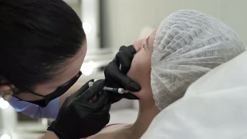 Patient Undergoes a Nonsurgical Face Lift Procedure During Which Doctor Performs an Injection Into