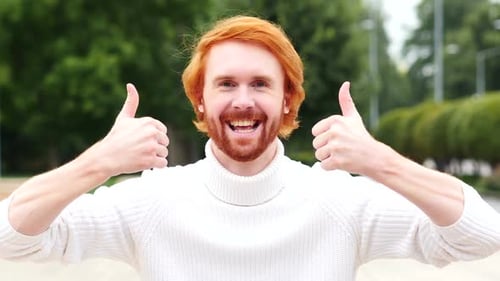 Thumbs Up with Both Hands By Man with Red Hairs Outdoor