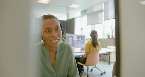 Geschäftsperson mit Headset bei einem Videoanruf in einem Büro, Telemarketing, Call Center