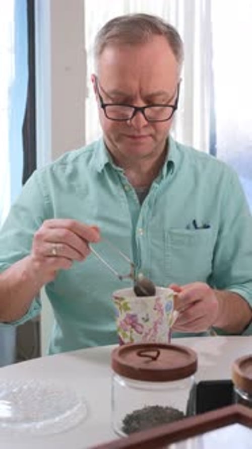 Adult Man Enjoying a Cup of Tea at Home