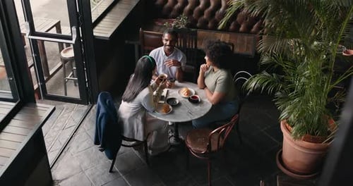 Friends, group and talking in coffee shop for communication catch up or university reunion