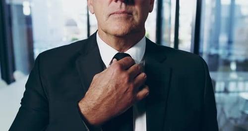 4k video footage of an unrecognizable businessman adjusting his tie in the office