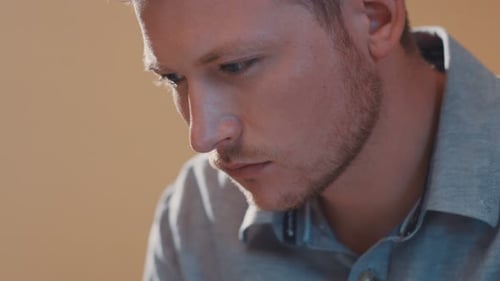 A Man's Face Plan Uses a Laptop Look at the Screen In Reflection Pondered Freelancer Blue Eyes Shot