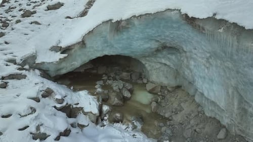 Stunning View of a Blue Ice Glacier Cave and Snow