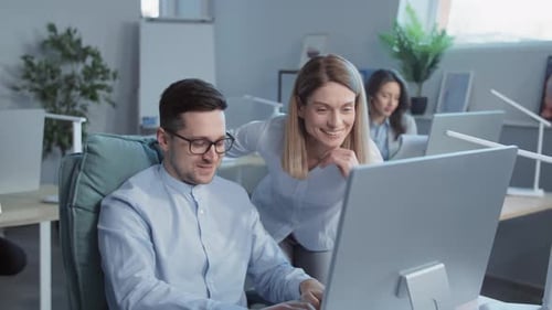 Close Up Man and Woman Talking Use Computer Working Together in a Modern Office On Background
