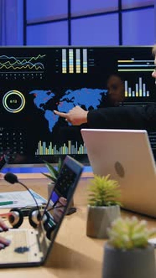 Business Meeting with Global Data Analysis on Screen