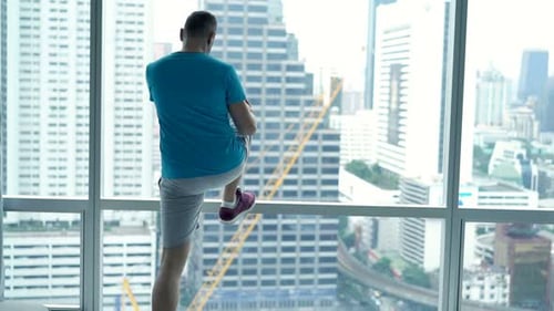 Young Man Exercising, Doing Warmup by Window in Gym Active