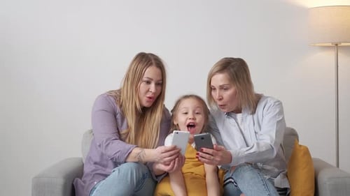 Three Generations Enjoying Mobile Device Together