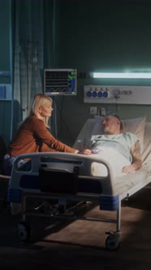 Loving Woman Visits Senior Man Undergoing Therapy in Ward