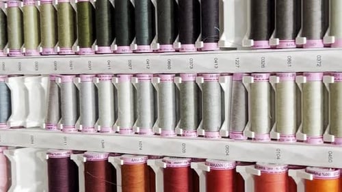 Many Rows of Spools for Threads of Different Colors for Sewing Machines and Household Purposes