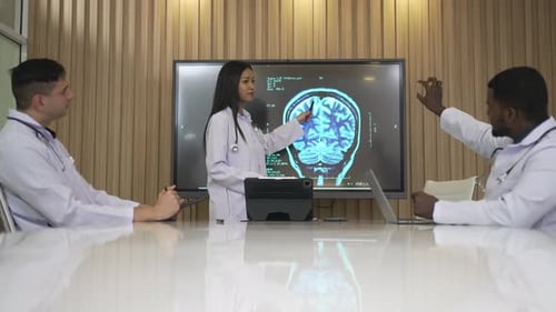 Medical Team Discussing Brain Scan in Modern Office