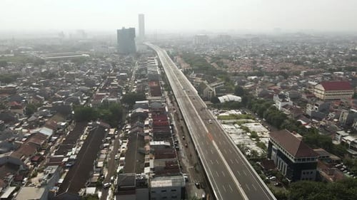 Aerial View Over Highway With Buildings And Houses In Jakarta Downtown, Indonesia - drone shot