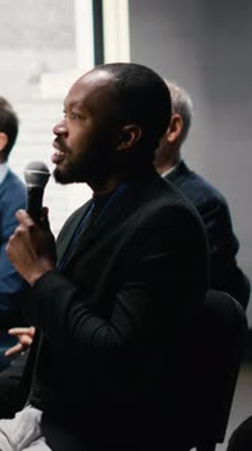 Vertical Video Business Conference Hall Filled with Seating and Active Audience