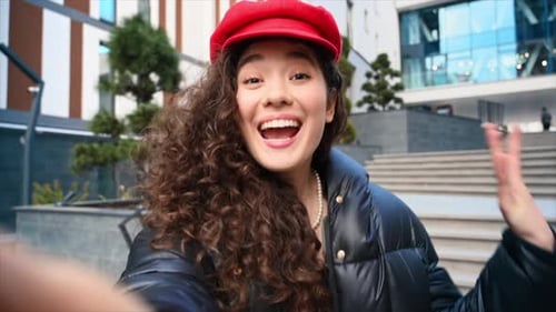 Cheerful Woman Talking to Camera Outdoors