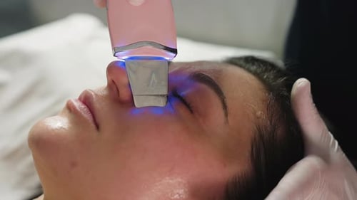 Beauty Specialist Extracting Pimples With Ultrasonic Wand During Spa Treatment
