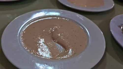 Hand Dips Pita Bread Into Creamy Hummus