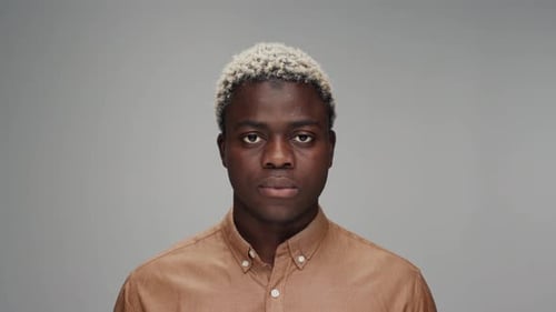Young Adult Man Stares Directly at Camera