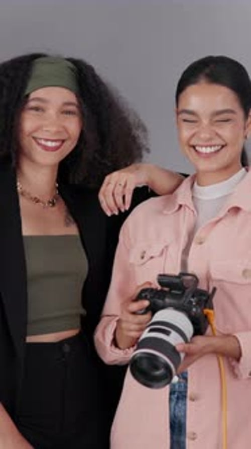 Two Smiling Women with Camera in Studio Portrait