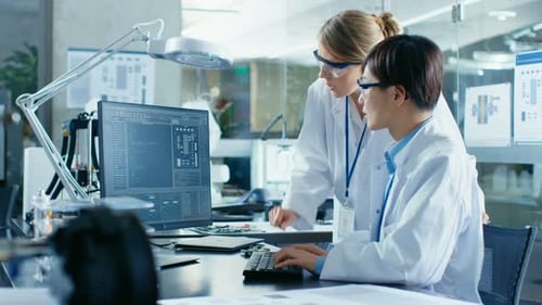 Scientists Working on Computer in Modern Laboratory