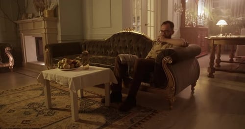 Man Relaxing on Couch with Drink