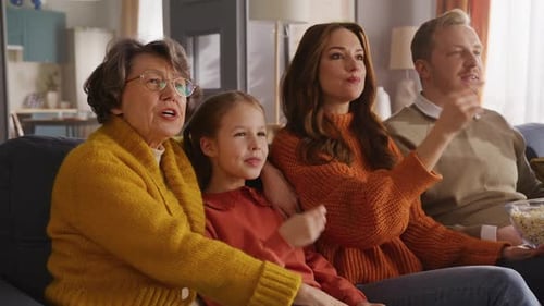 Family Relaxing Together, Watching Screen and Eating Popcorn