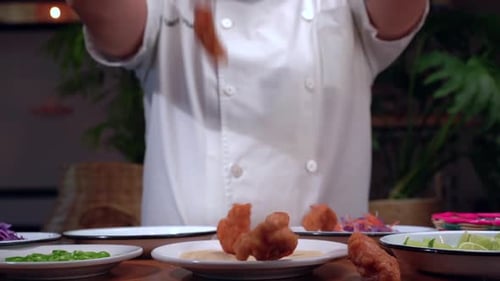 Crispy Chicken Falling onto Tortilla in Kitchen