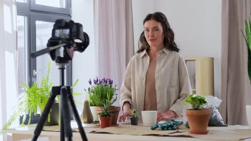 Woman gardener recording vlog in a bright home setting