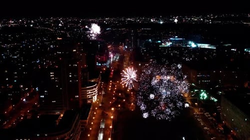 Fireworks celebrating a new year in the middle of a big city