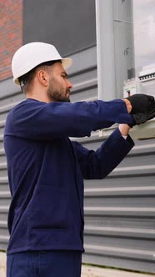 Electrician Installing Electrical Panel in Cottage Community