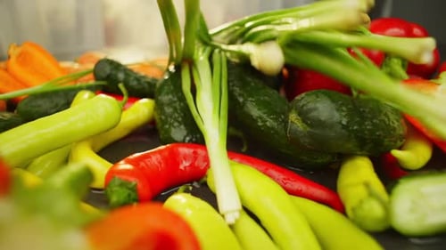 Slow Motion Video of Green Onions Falling on Vegetables