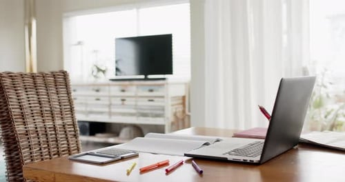 Close up of home office table with laptop, calculator and notebook, slow motion