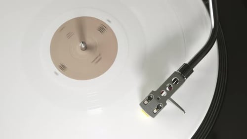 White Vinyl Record Spinning on Turntable