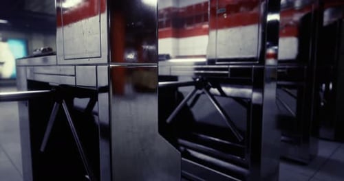 Turnstiles in a Subway Station During Early Morning Hours in an Urban Area