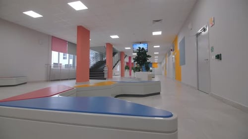 Multicolor Benches in Light Empty Hall of School Building
