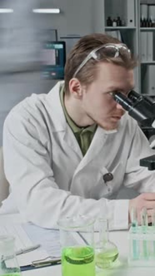 Focused Scientist Working in Lab Using Microscope