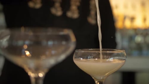 Bartender creates a refreshing martini cocktail in a modern bar setting