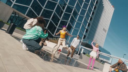 Young And Stylish Female Hip Hop Dancer Freestyling On City Street In Circle Of Trendy Friends. Gr