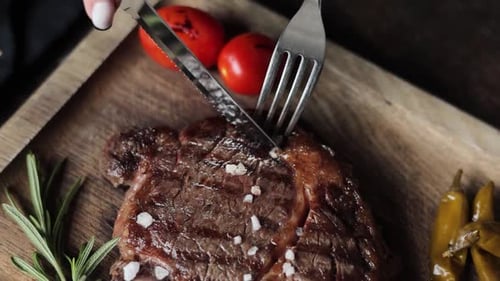 a restaurant guest cuts a steak
