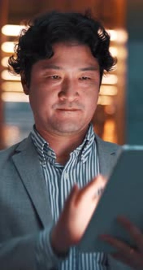 City, night and businessman on tablet in Japan for communication, typing email and networking